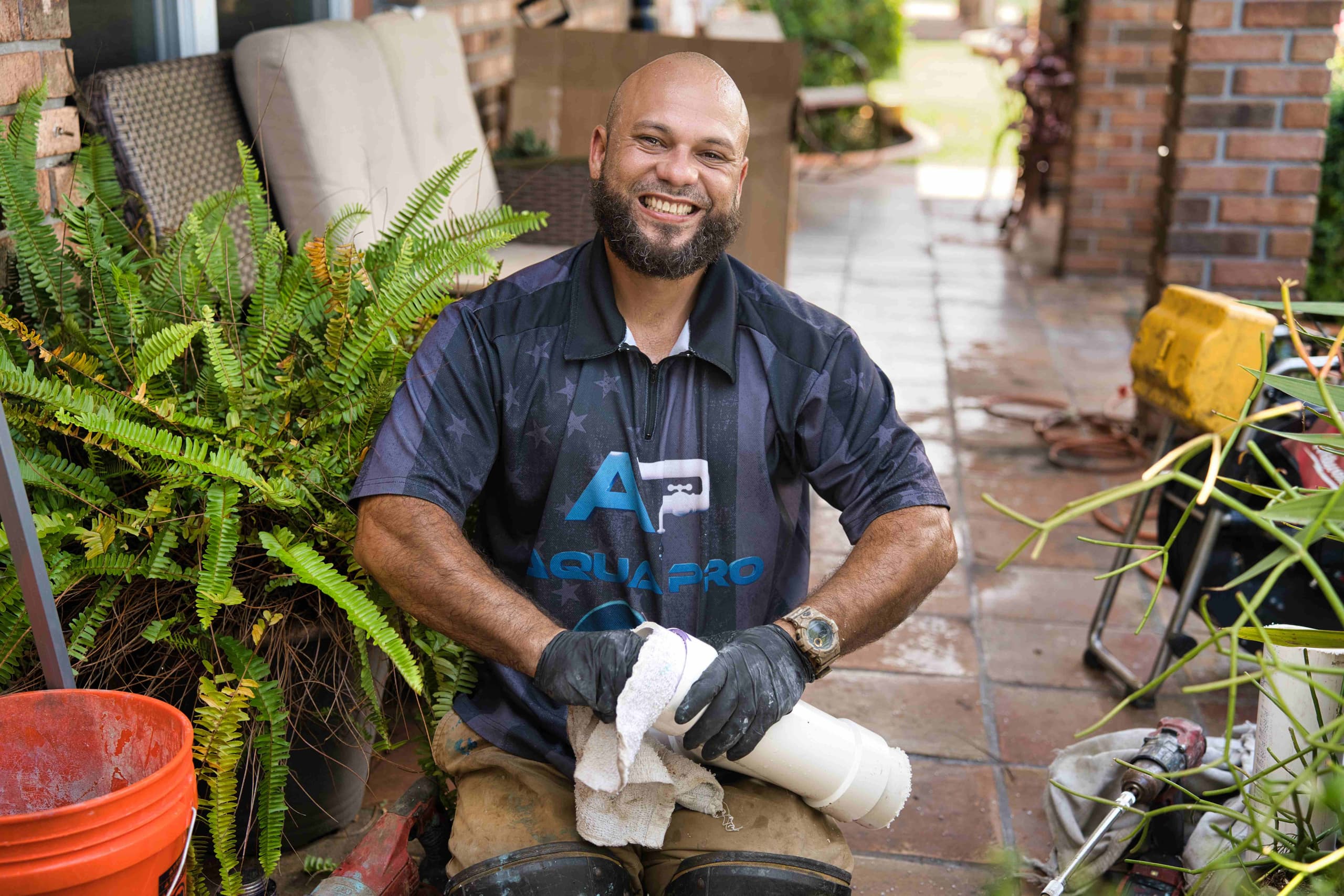 An Aqua Pro plumber holding PVC pipe