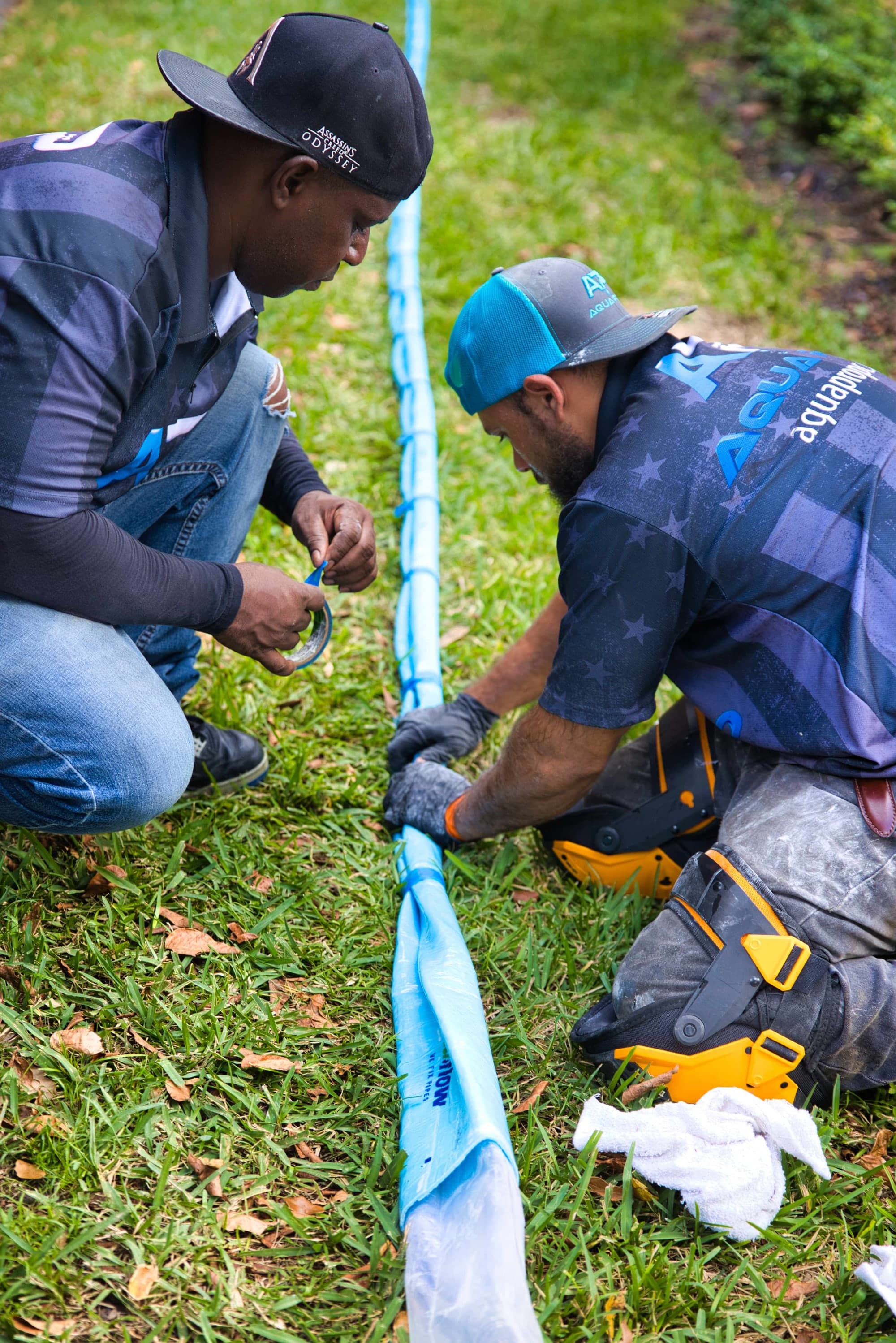 Aqua Pro crew handling liner material on site