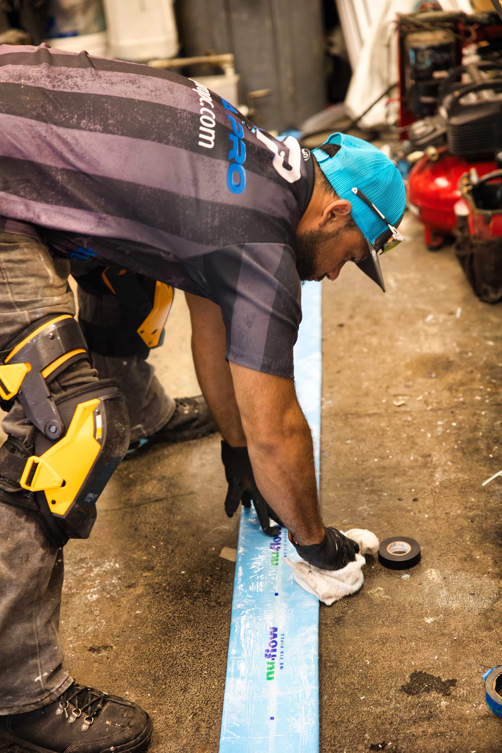 An Aqua Pro technician measuring liner material before an installation