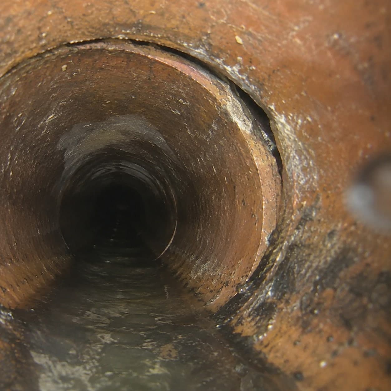 Illustration: camera view of a cast iron joint that has shifted out of line