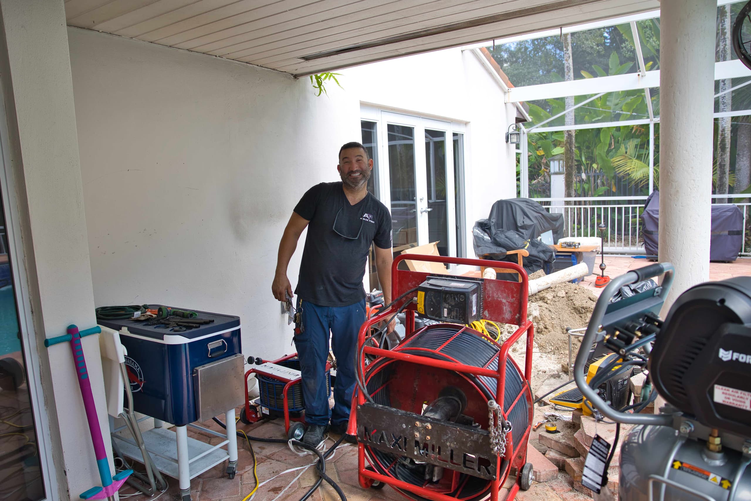 Lining equipment set up on a covered patio during a trenchless repair