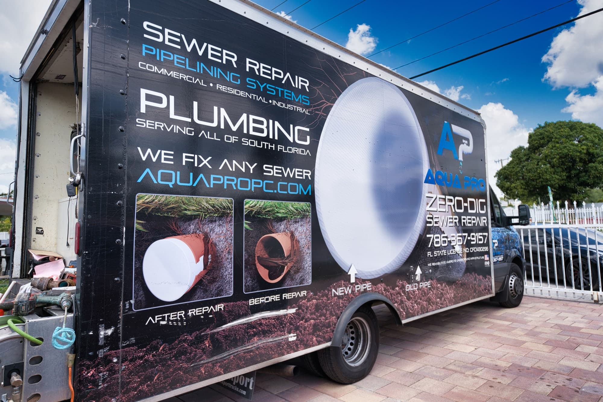 The side of an Aqua Pro service truck with sewer repair graphics